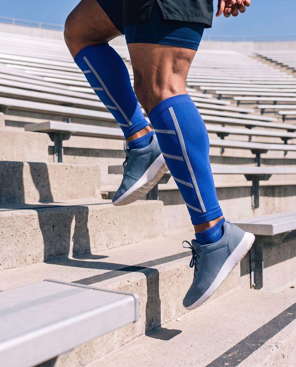 Manchons de compression bleus pour mollets portés pendant une séance dans les escaliers d'un stade